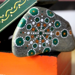 Piedra de la Costa Brava pintada con acrílico a pincel en tonos verdes y naranjas